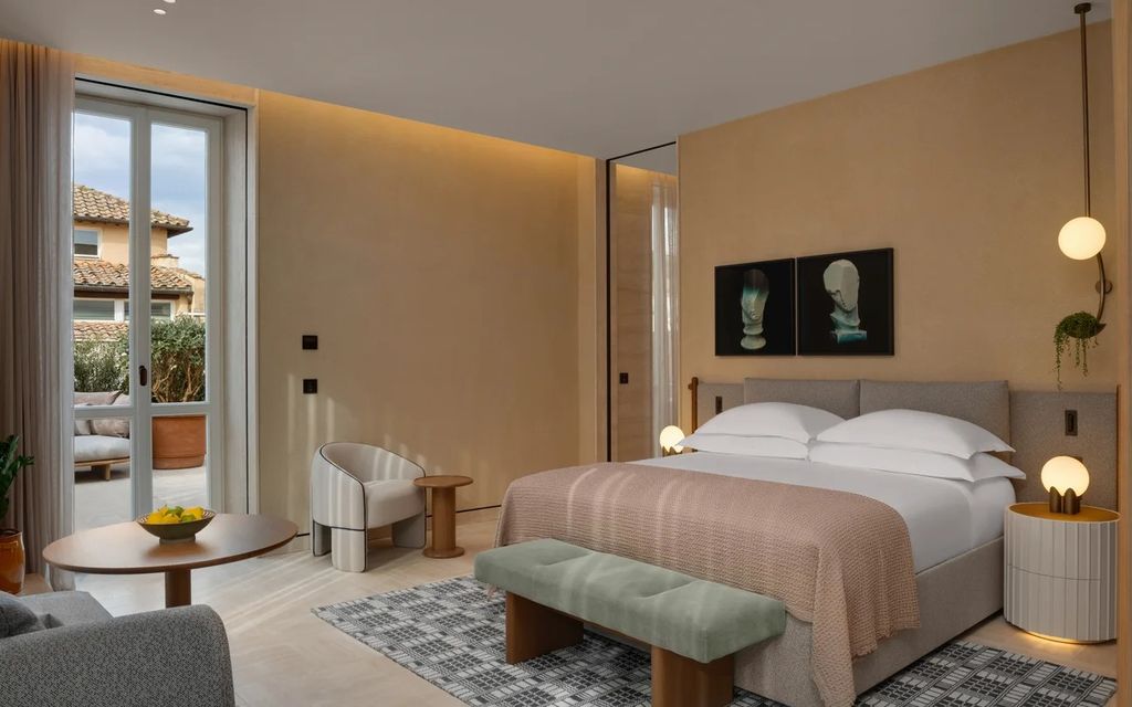 Image may contain Home Decor Indoors Interior Design Corner Plant Lamp Bed Furniture Bench Person Rug and Cushion