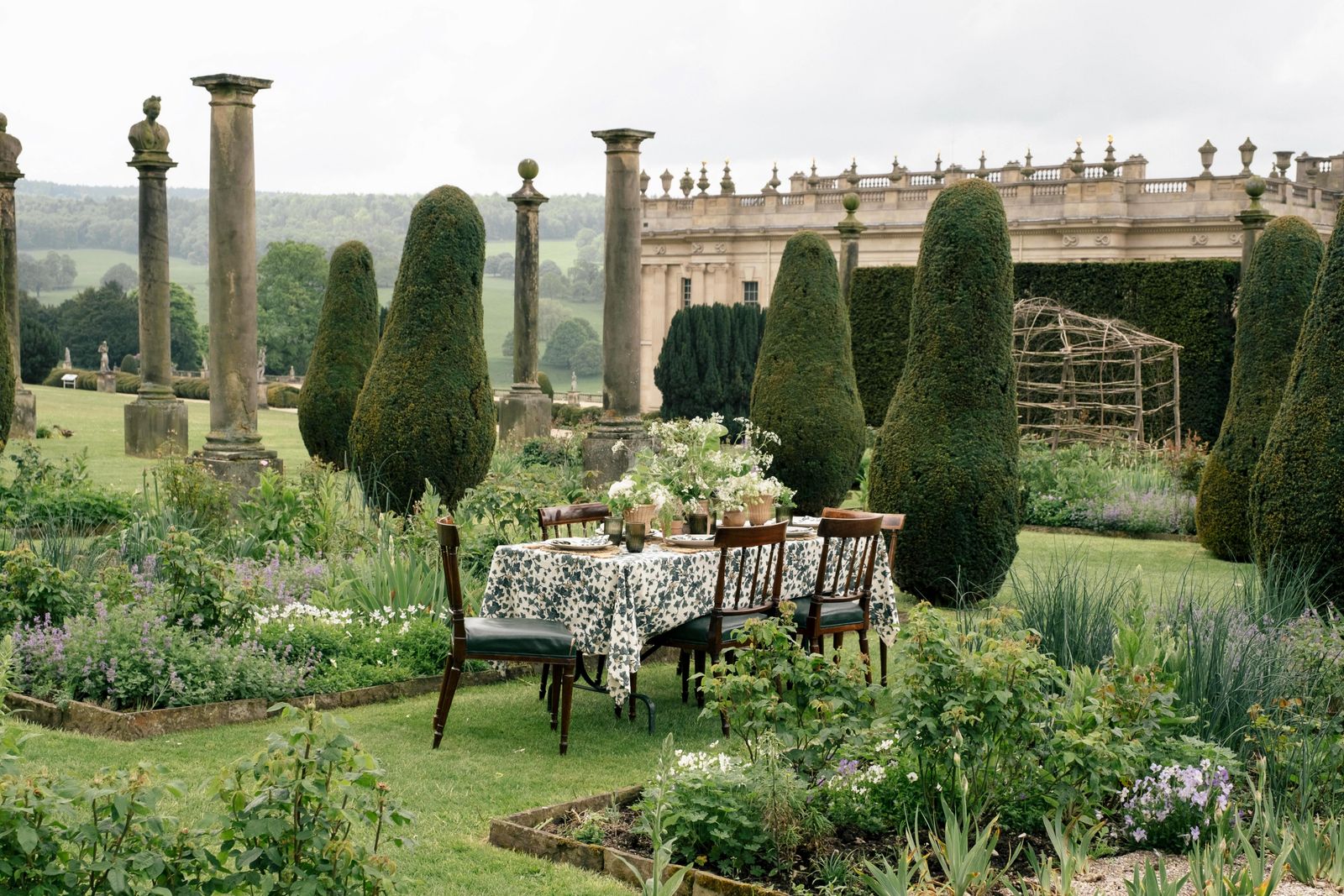 Image may contain Garden Nature Outdoors Grass Plant Backyard Yard Chair Furniture Dining Table Table and Park