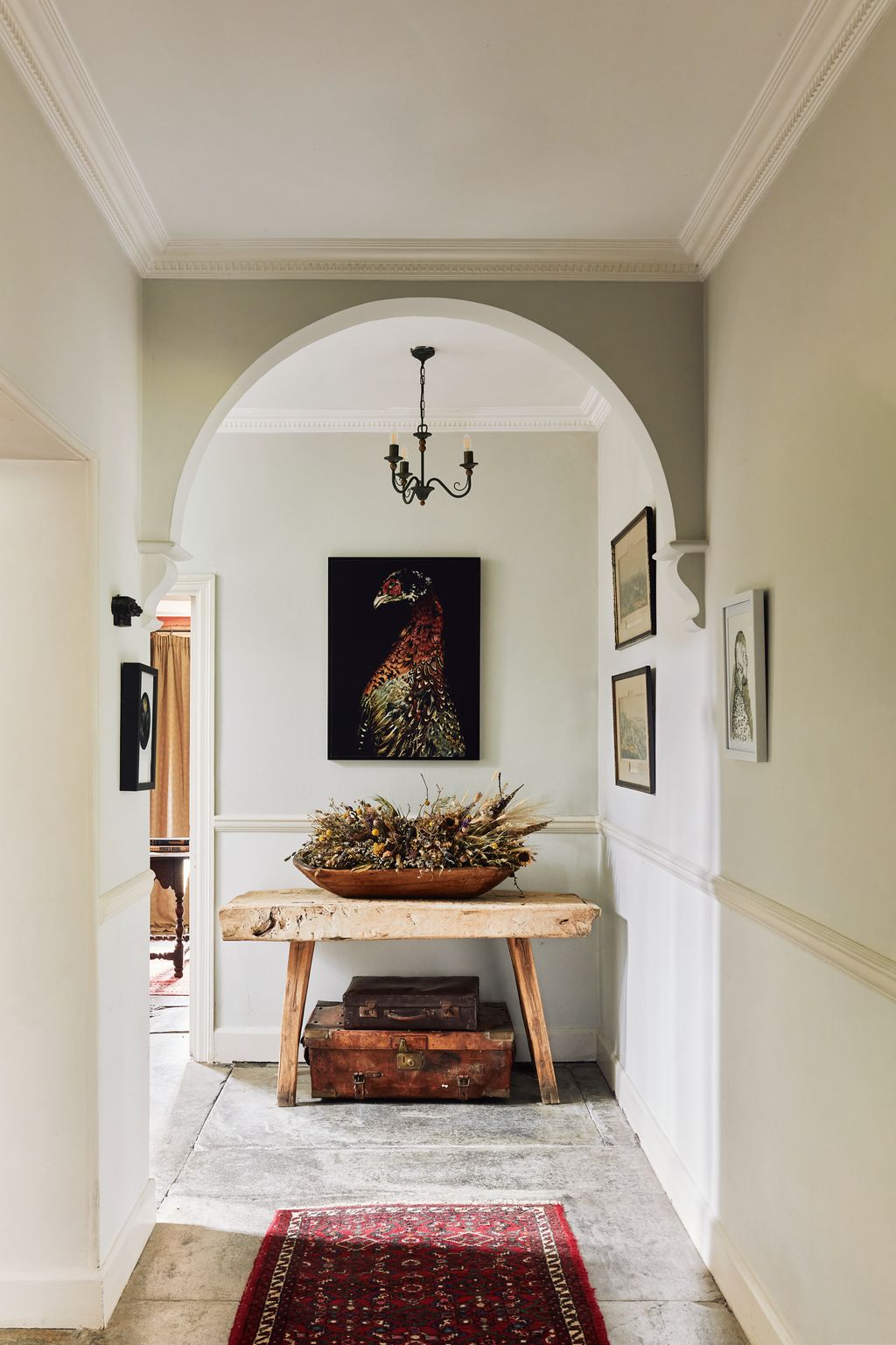 Image may contain Home Decor Rug Desk Furniture Table Box Art Painting Plant Indoors Arch and Architecture