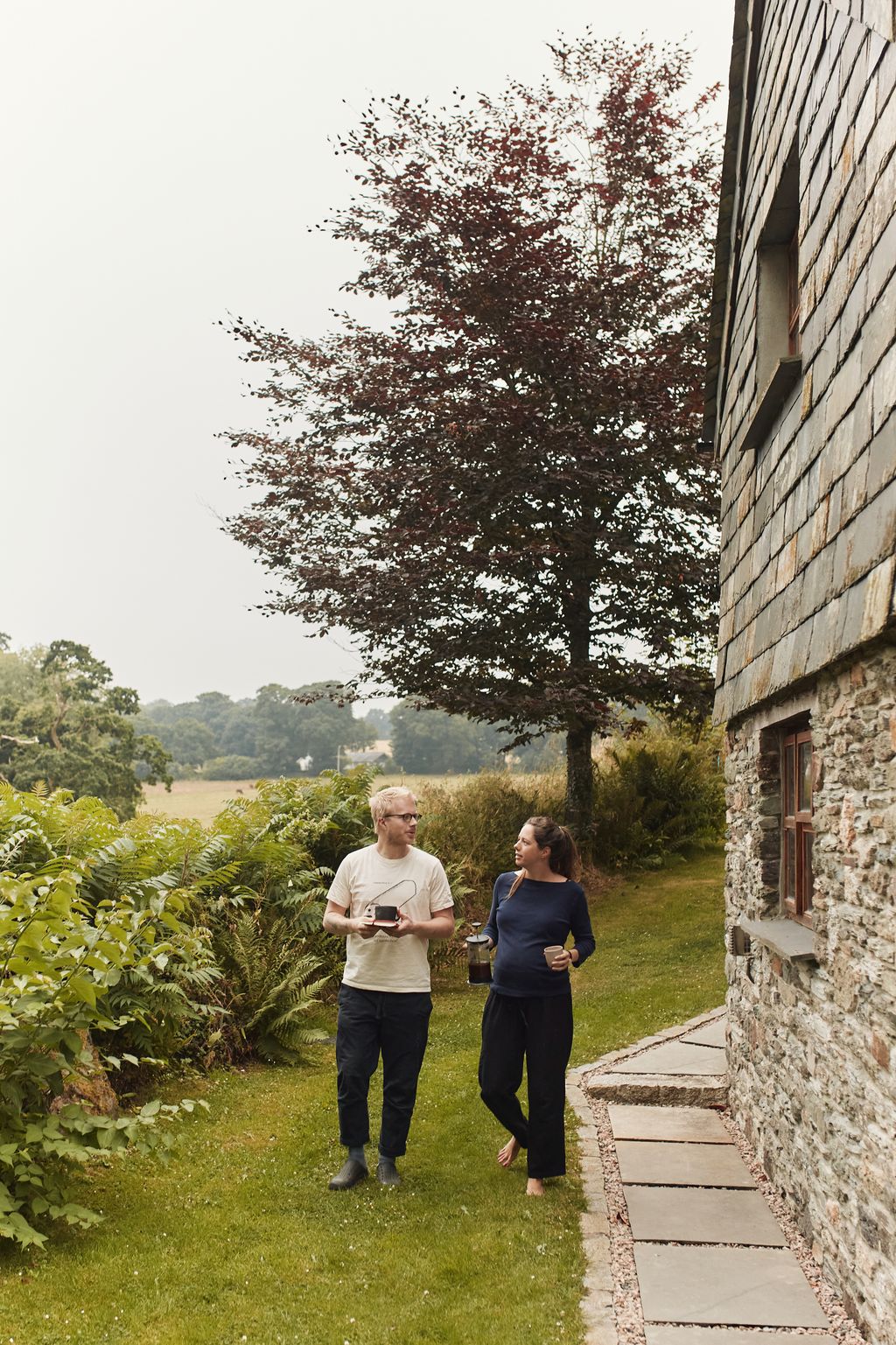 Image may contain Person Walking Grass Plant Clothing Pants Path Adult Vegetation Face Head and Photography