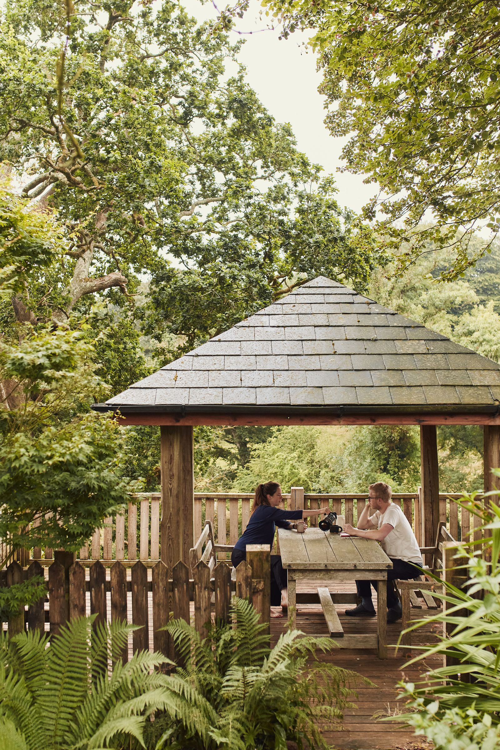 Image may contain Architecture Building Outdoors Shelter Adult Person Nature Yard Plant Vegetation and Indoors