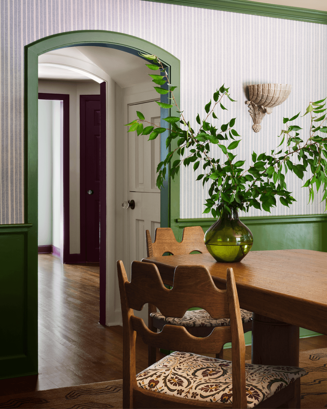 Image may contain Indoors Interior Design Wood Floor Flooring Hardwood Chair Furniture Table and Plant