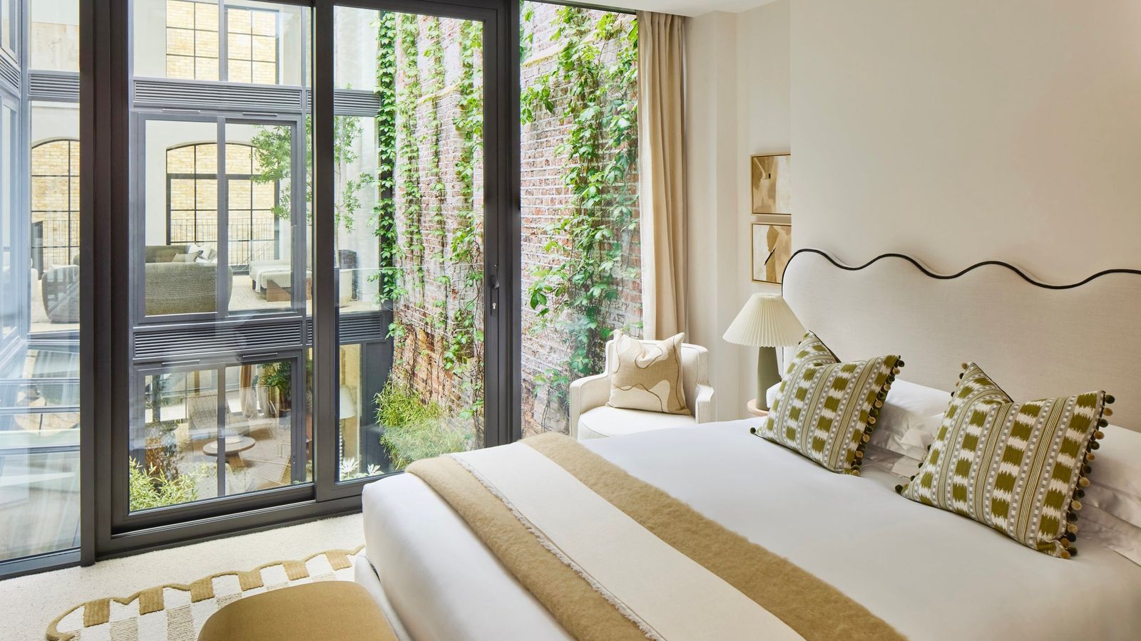 Image may contain Lamp French Window Window Cushion Home Decor Door Bed Furniture Chair and Indoors