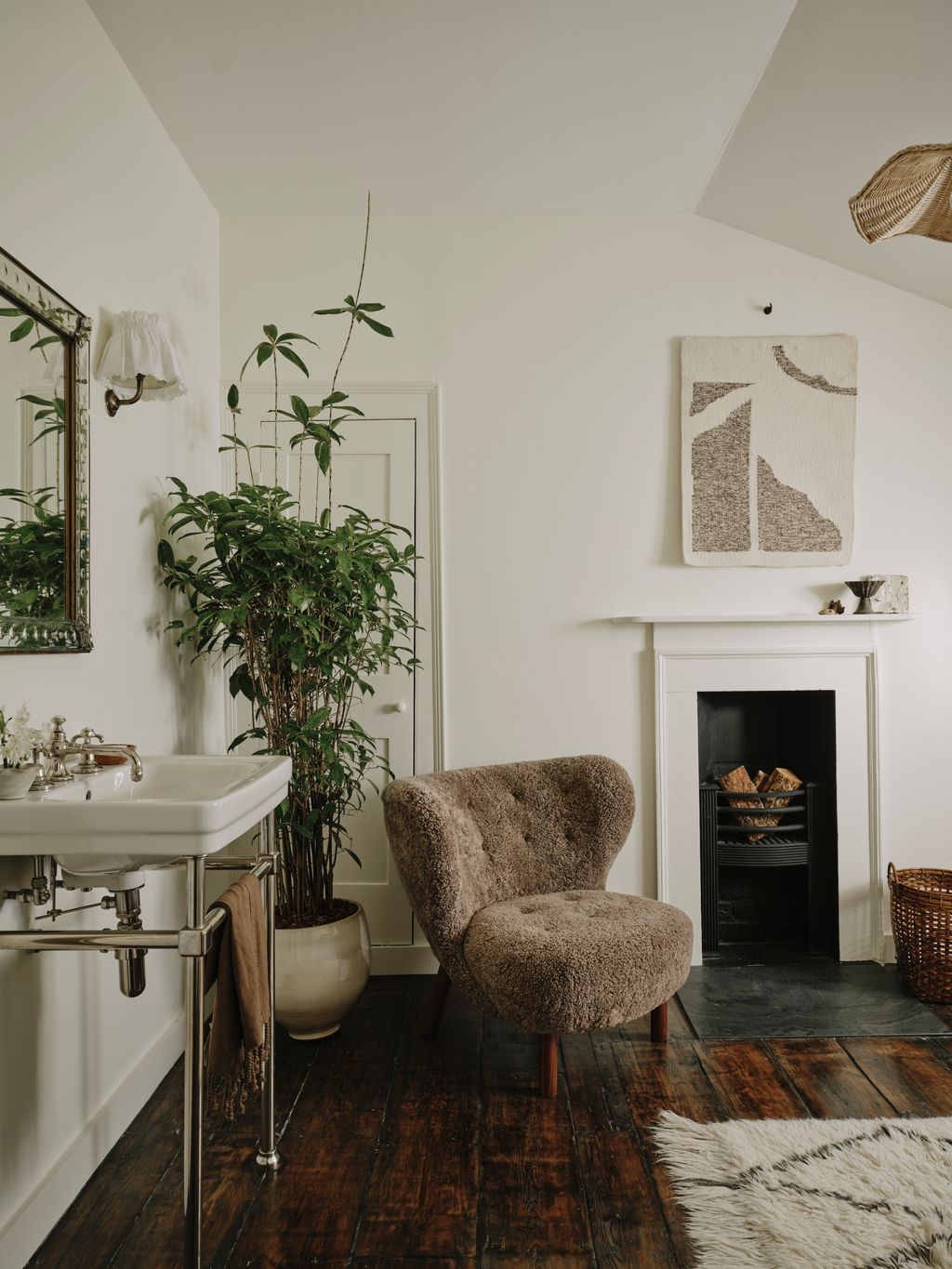 Image may contain Plant Chair Furniture Home Decor Rug Sink Indoors Interior Design Fireplace Wood and Lamp