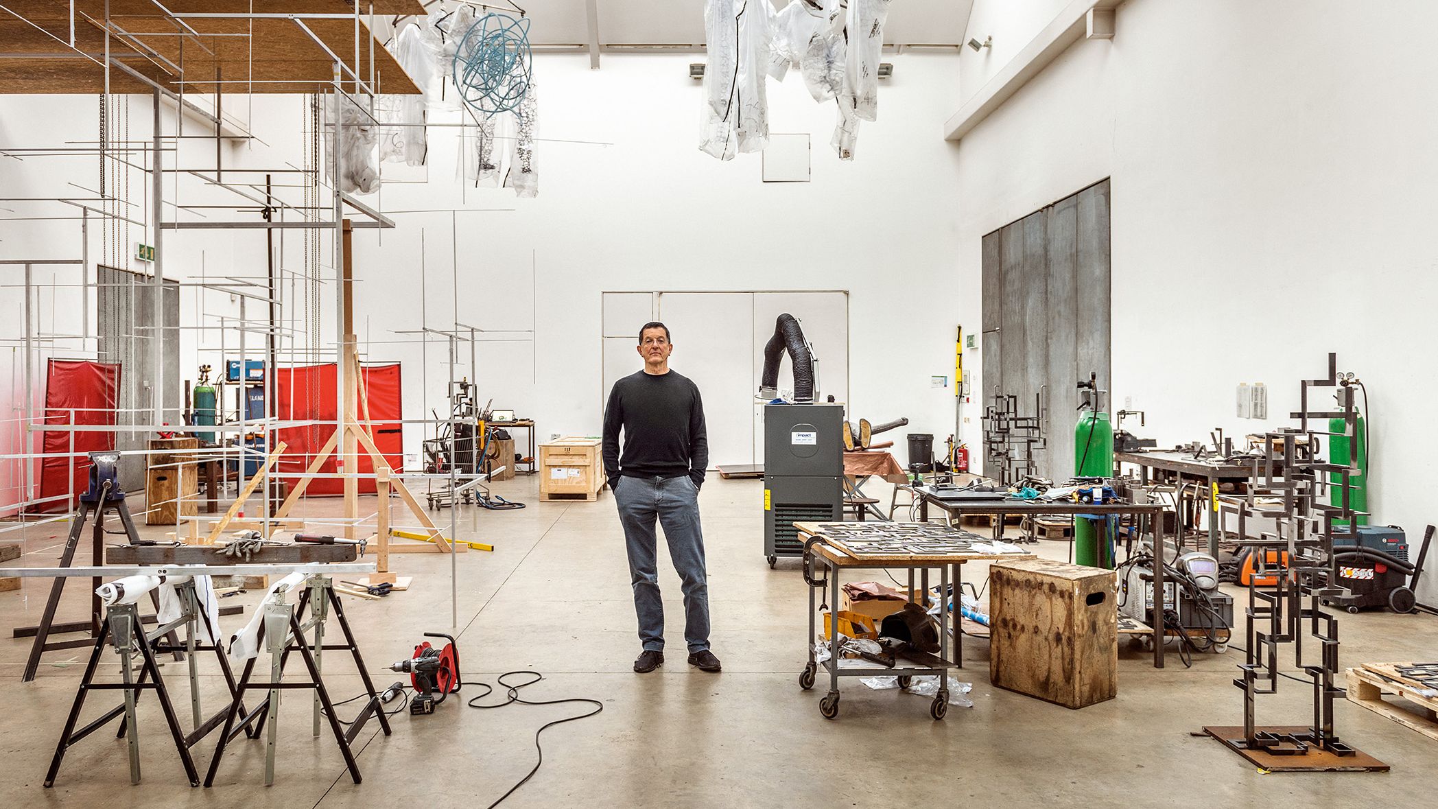 Image may contain Architecture Building Factory Manufacturing Workshop Person Clothing Footwear Shoe and Box