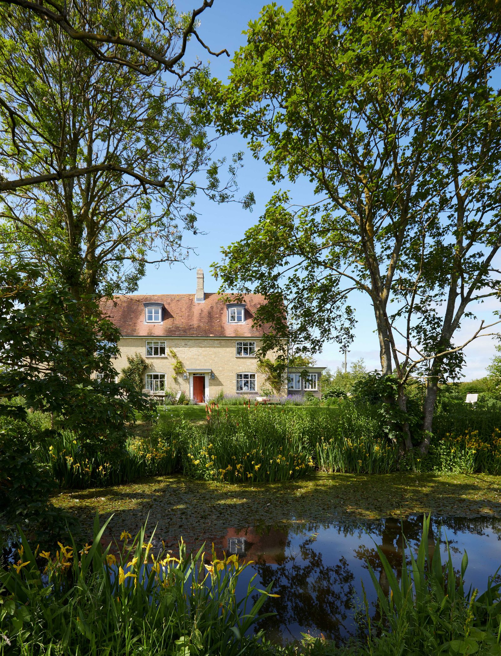 Image may contain Nature Outdoors Pond Water Scenery Architecture Building Cottage House Housing Land and Plant