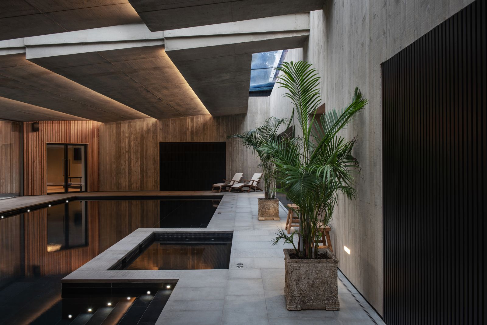 Image may contain Indoors Interior Design Plant Chair Furniture Wood Panels and Water