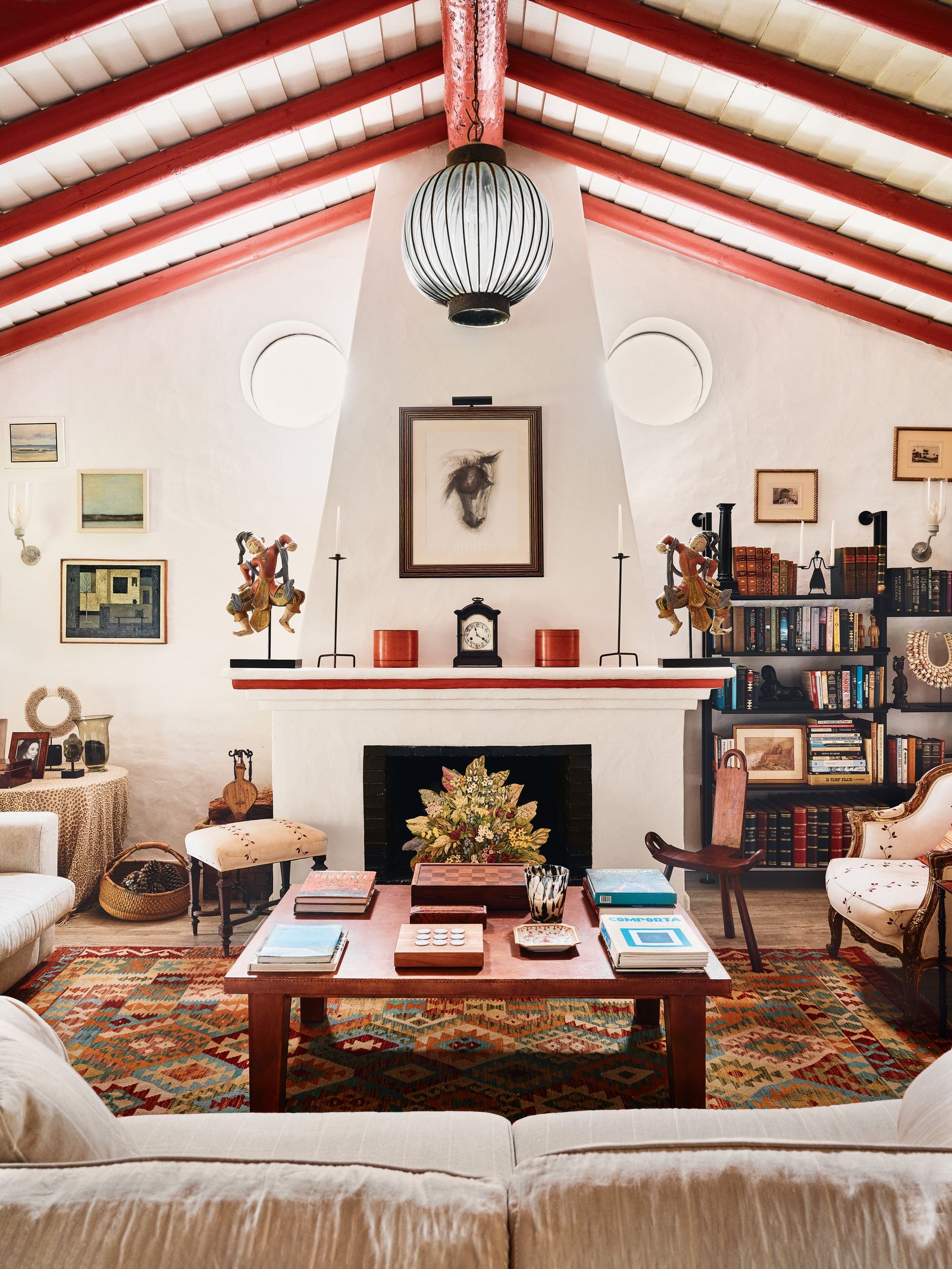 Image may contain Home Decor Chair Furniture Art Painting Rug Desk Table Book Publication Couch and Architecture