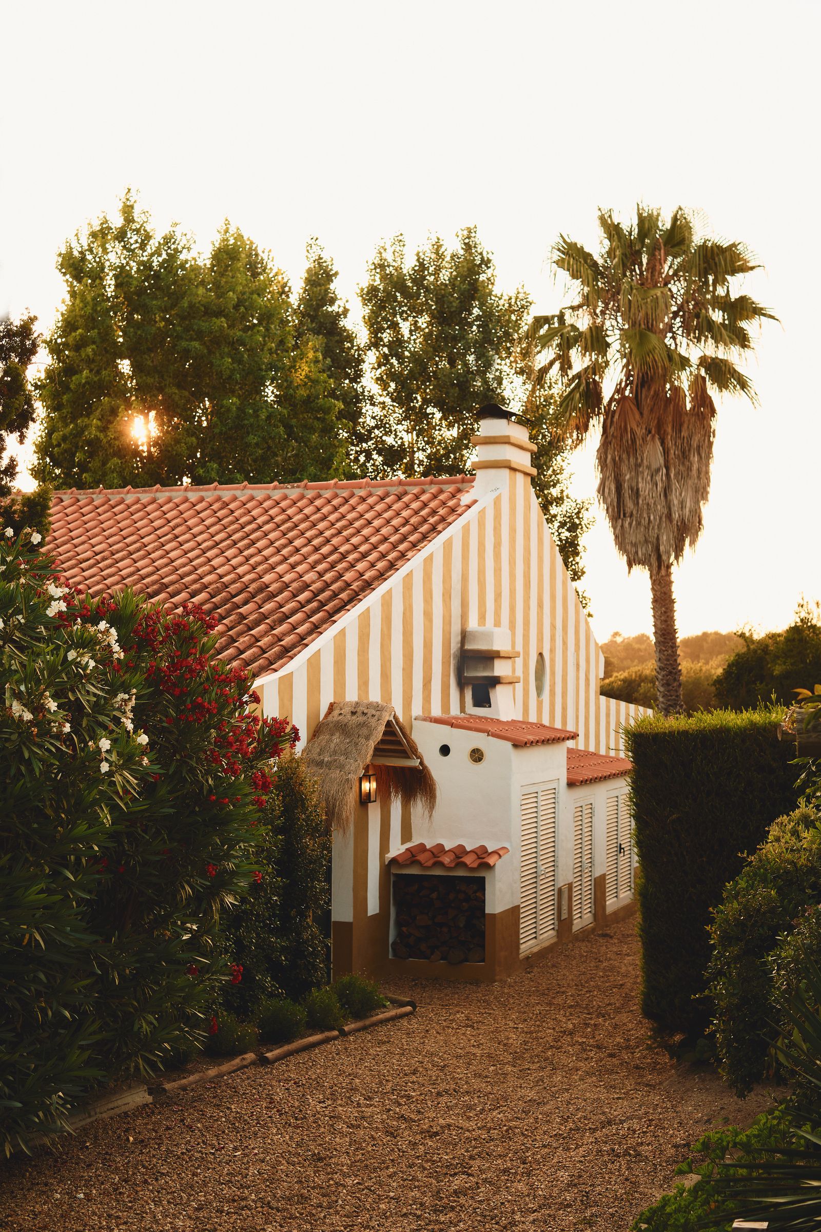 Image may contain Plant Tree Architecture Building Cottage House Housing Outdoors Shelter Lamp Grass and Villa