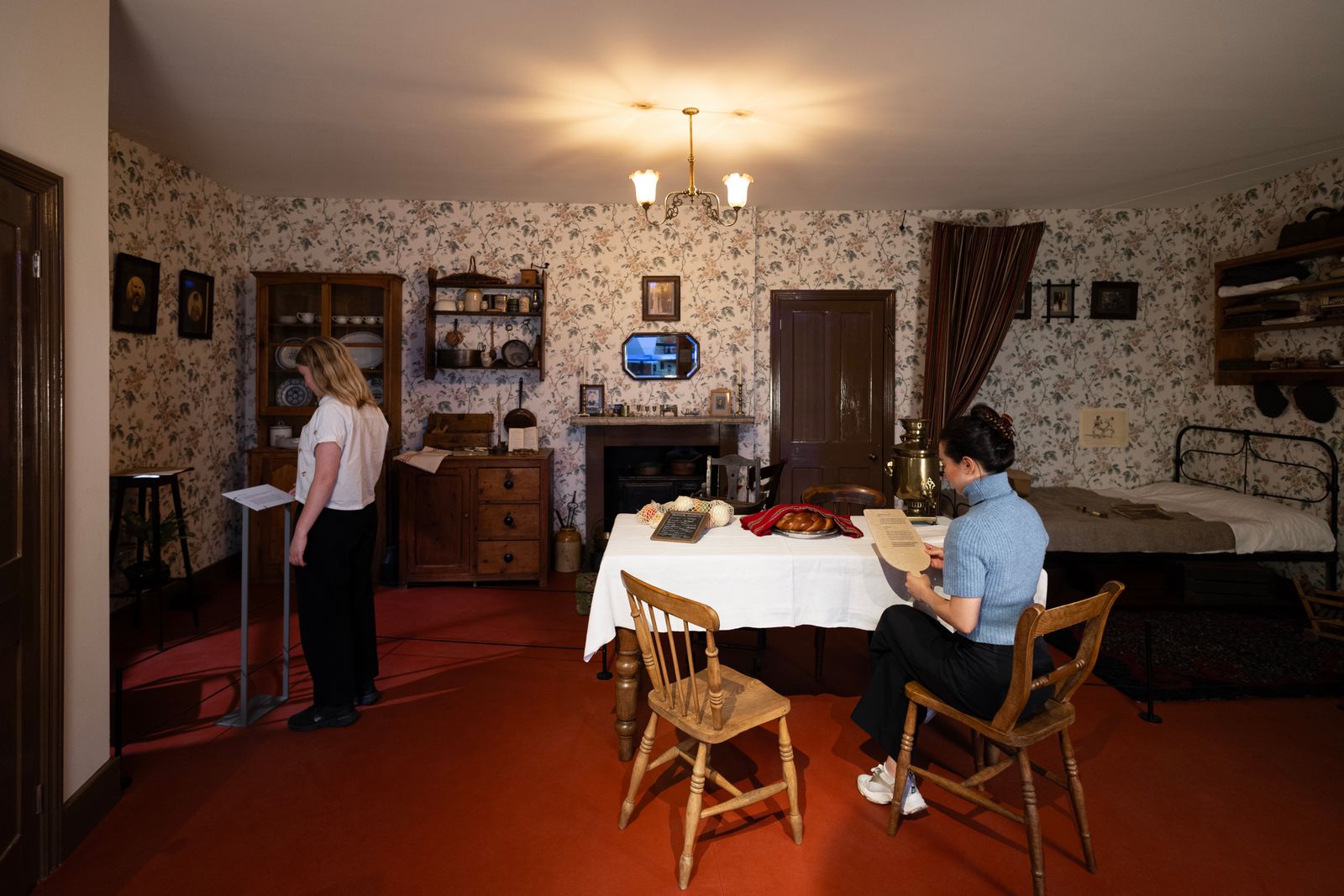 Image may contain Lamp Chair Furniture Person Adult Art Painting Dining Table Table Clothing Footwear and Shoe