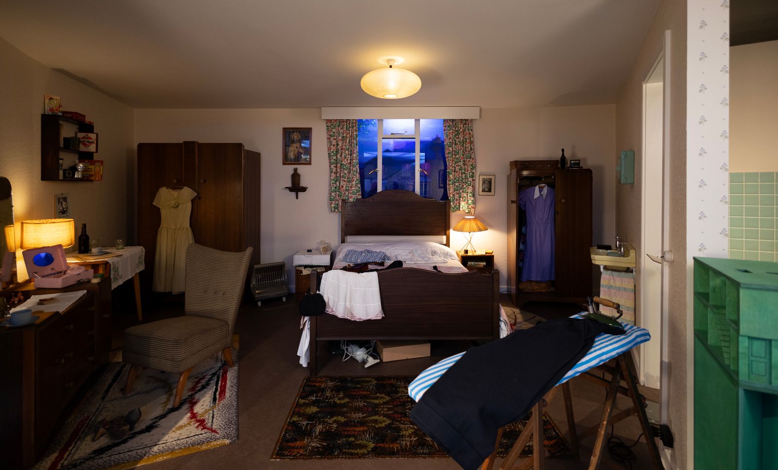 Image may contain Bed Bedroom Dorm Room Furniture Indoors Room Lamp Chair Home Decor Rug Art Painting and Person