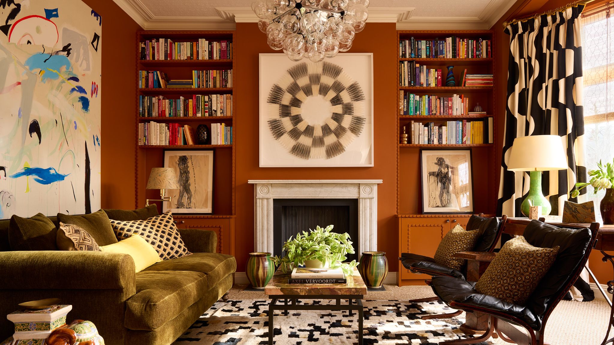 Image may contain Home Decor Lamp Rug Couch Furniture Architecture Building Indoors Living Room Room and Art