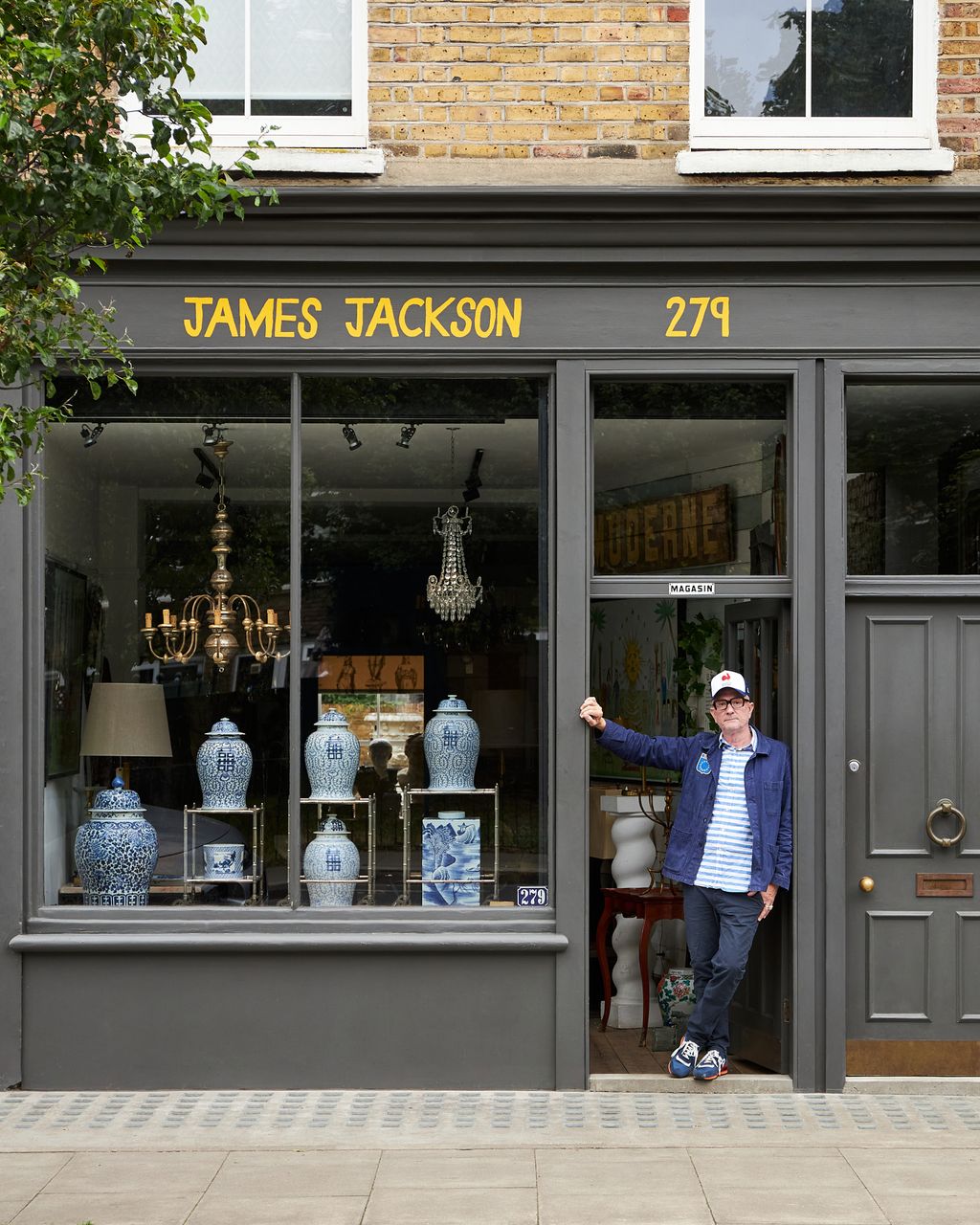 Image may contain Clothing Pants Person Lamp Footwear Shoe Hat Pottery Desk Furniture Table and Accessories