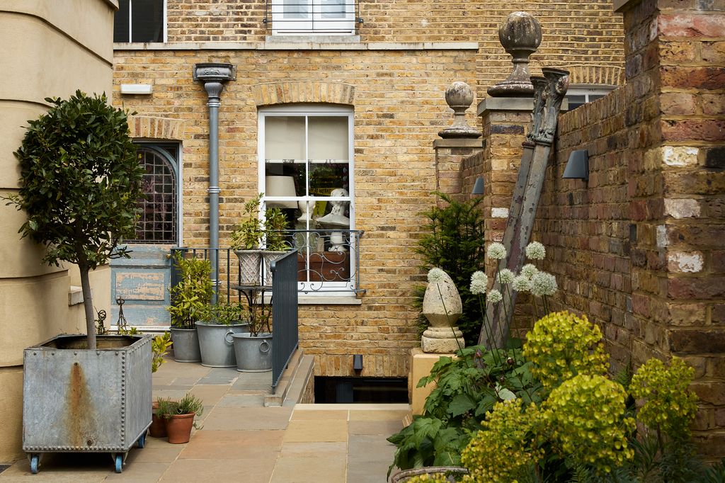 Image may contain Plant Potted Plant Jar Planter Pottery Vase City Road Street Urban Person and Architecture