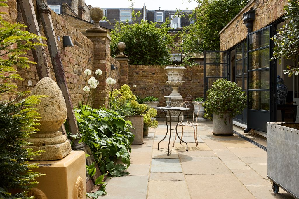 Image may contain Plant Potted Plant Backyard Nature Outdoors Yard Chair Furniture Desk Table Garden and Path