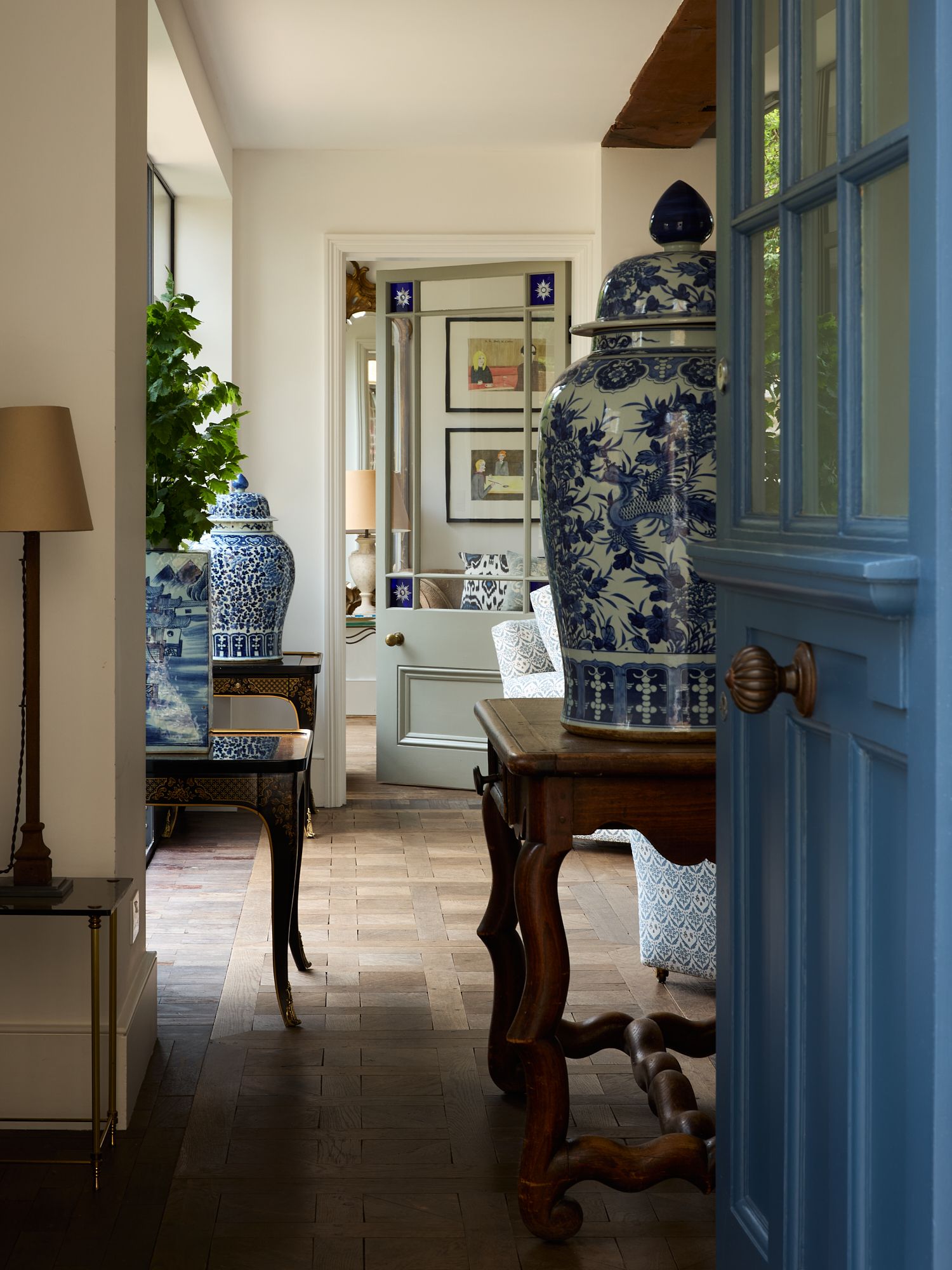 Image may contain Floor Lamp Flooring Indoors Interior Design Desk Furniture Table Art Painting Pottery and Chair