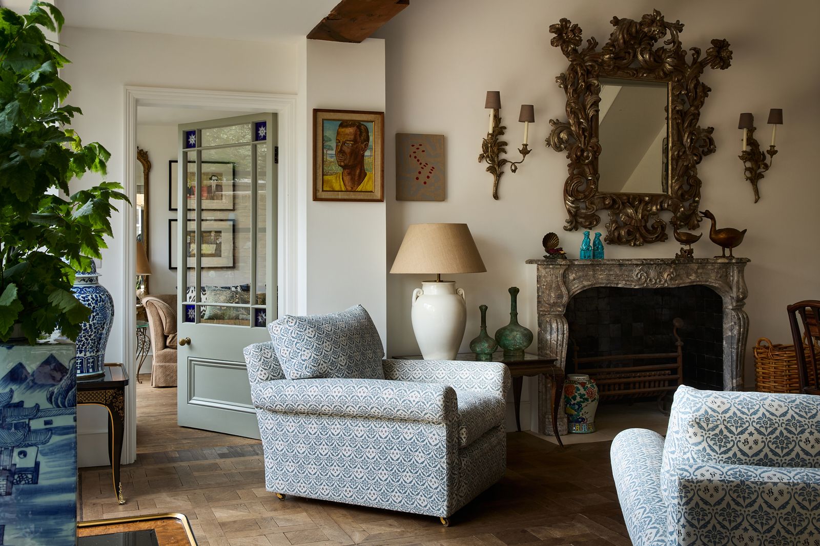 Image may contain Lamp Art Painting Home Decor Architecture Building Furniture Indoors Living Room Room and Chair