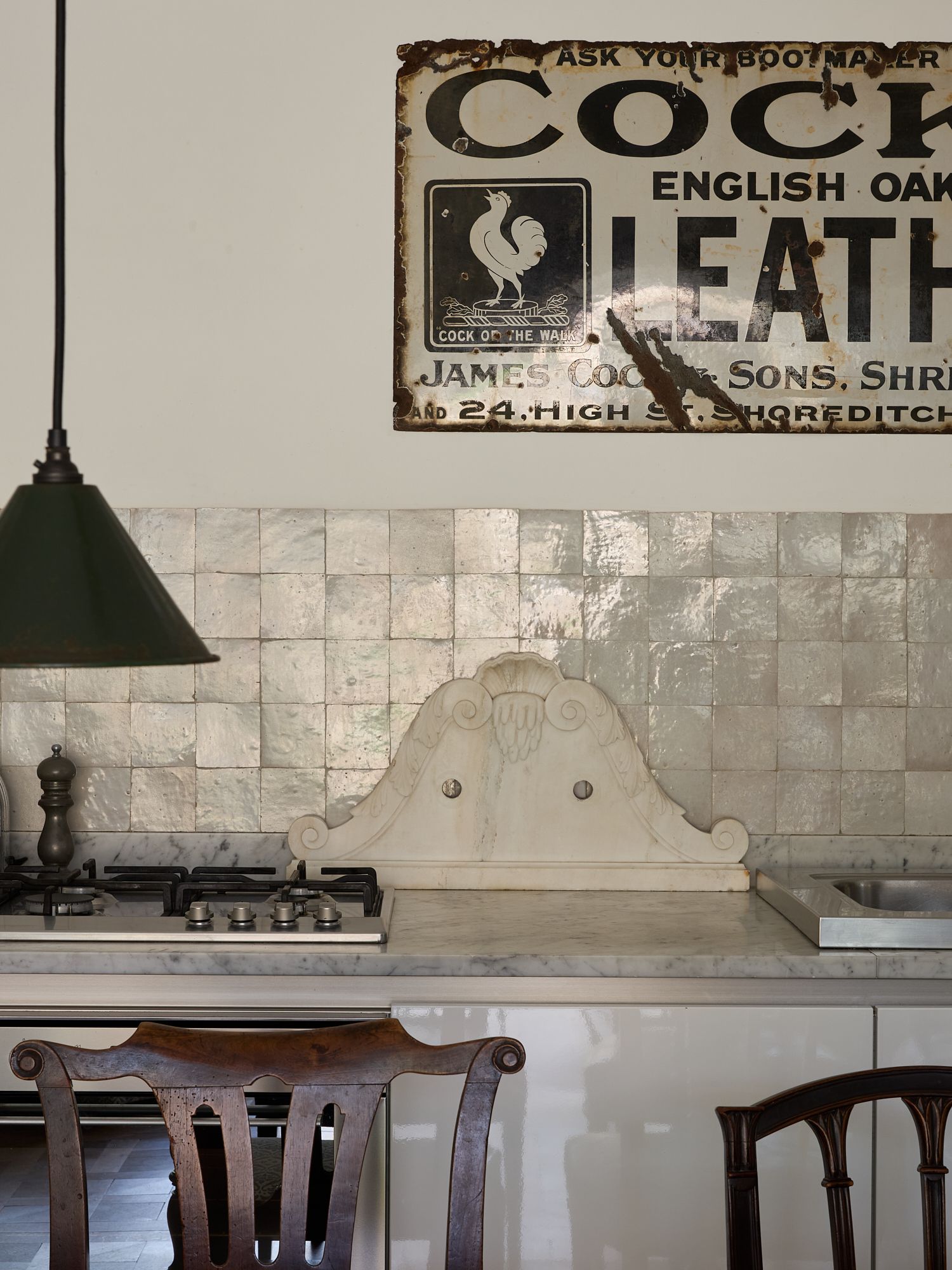 Image may contain Indoors Interior Design Chair Furniture Cooktop Kitchen Lamp Sink Dining Table and Table