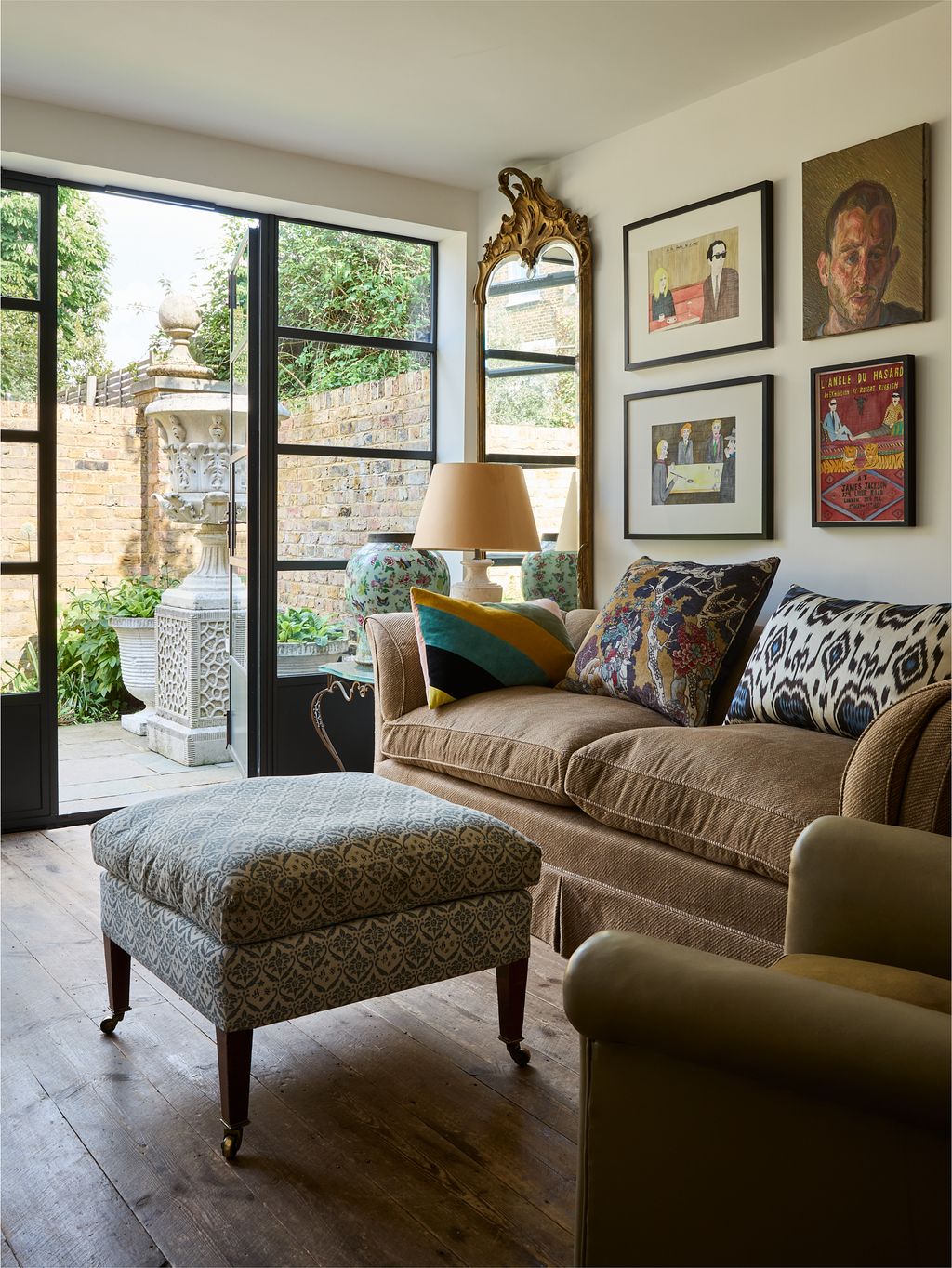 Image may contain Lamp Furniture Couch Person Art Painting Adult Plant and Bench