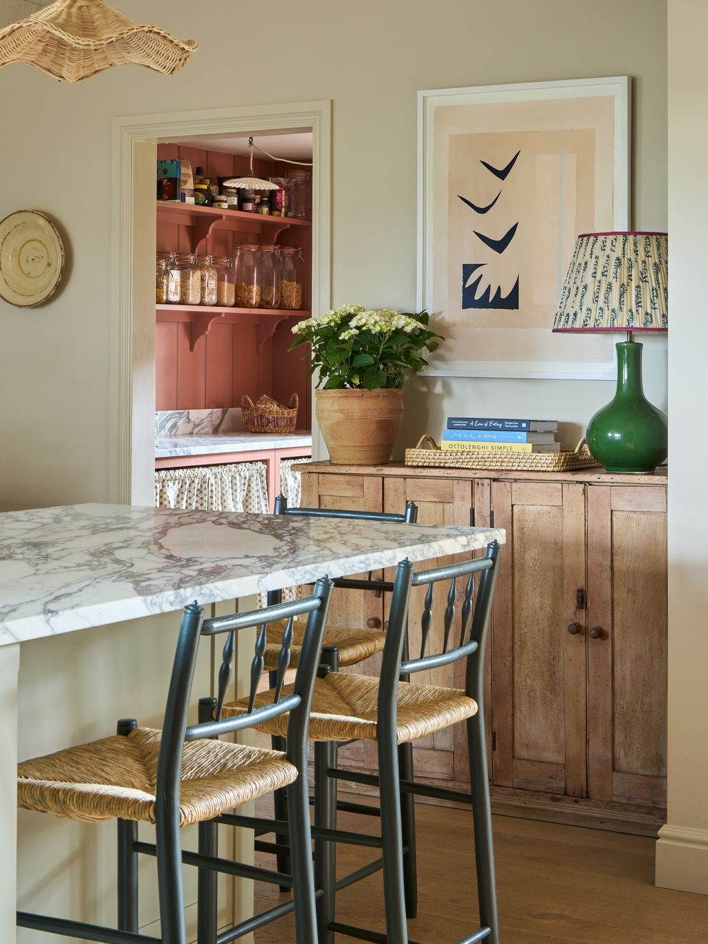 Image may contain Indoors Interior Design Lamp Chair Furniture Shelf Dining Table Table Kitchen Plate and Art