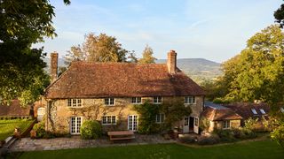 Image may contain Architecture Building Cottage House Housing Bench Furniture Manor and Person