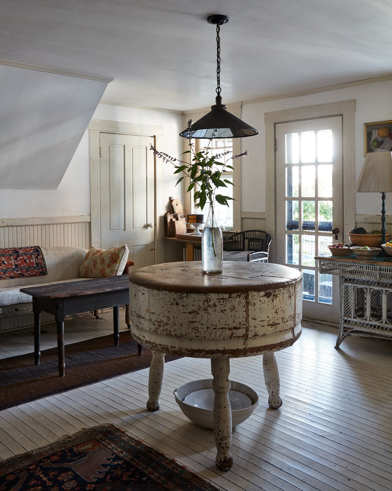 Image may contain Lamp Home Decor Coffee Table Furniture Table Indoors Interior Design Rug Couch Chair and Art