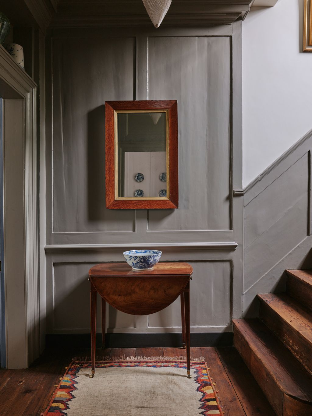 Image may contain Indoors Interior Design Home Decor Rug Wood Hardwood Stained Wood Architecture Building and Foyer