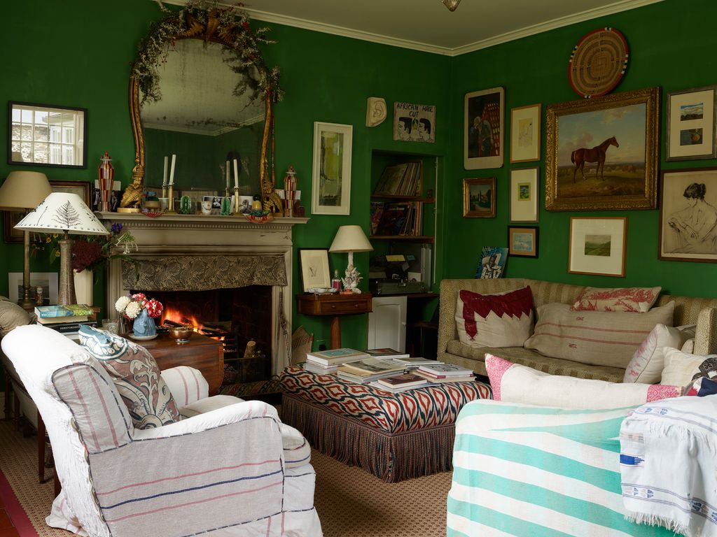 Image may contain Home Decor Lamp Architecture Building Furniture Indoors Living Room Room Fireplace Couch and Art