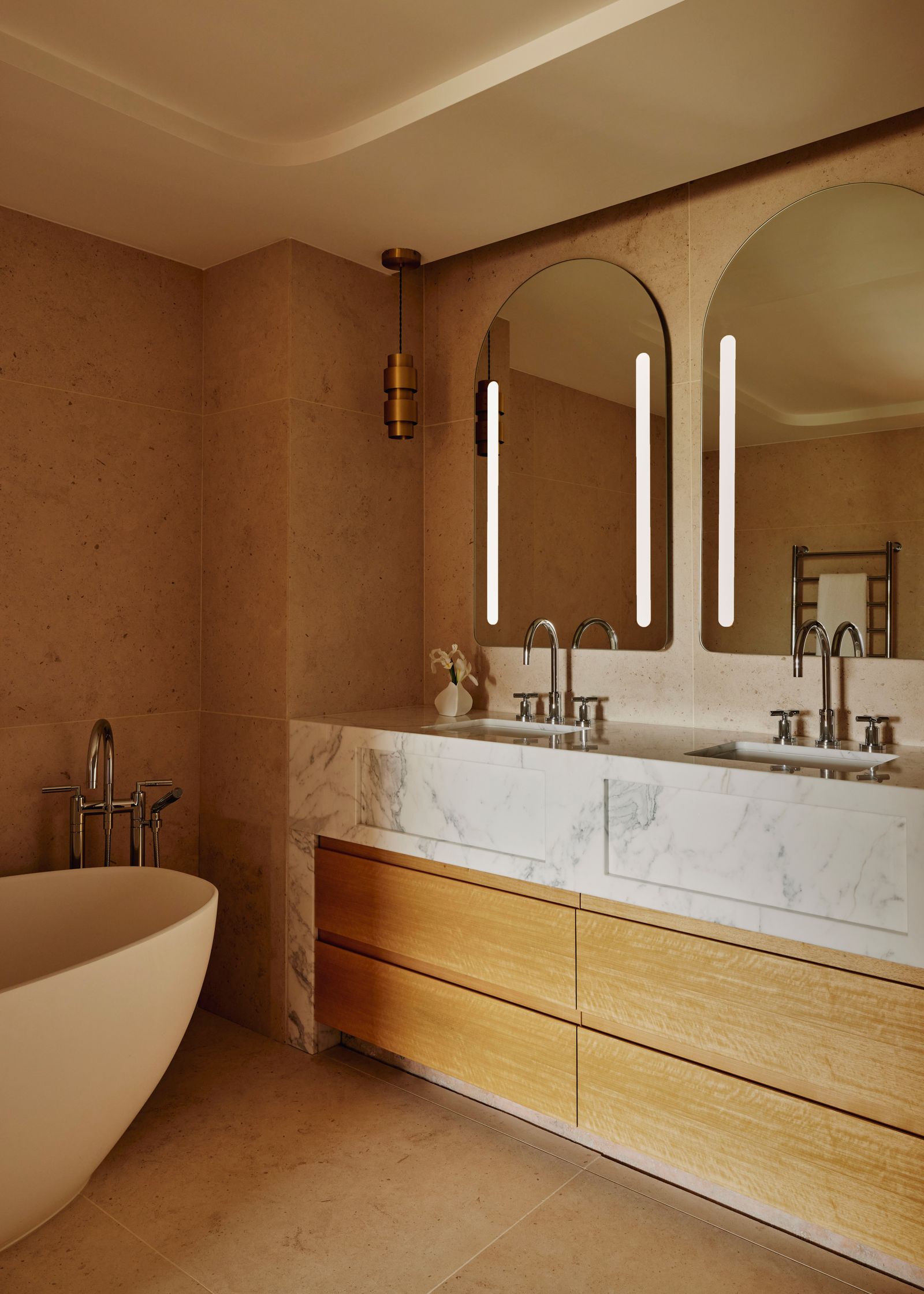 Image may contain Lamp Sink Sink Faucet Bathing Bathtub Person Tub Indoors and Interior Design