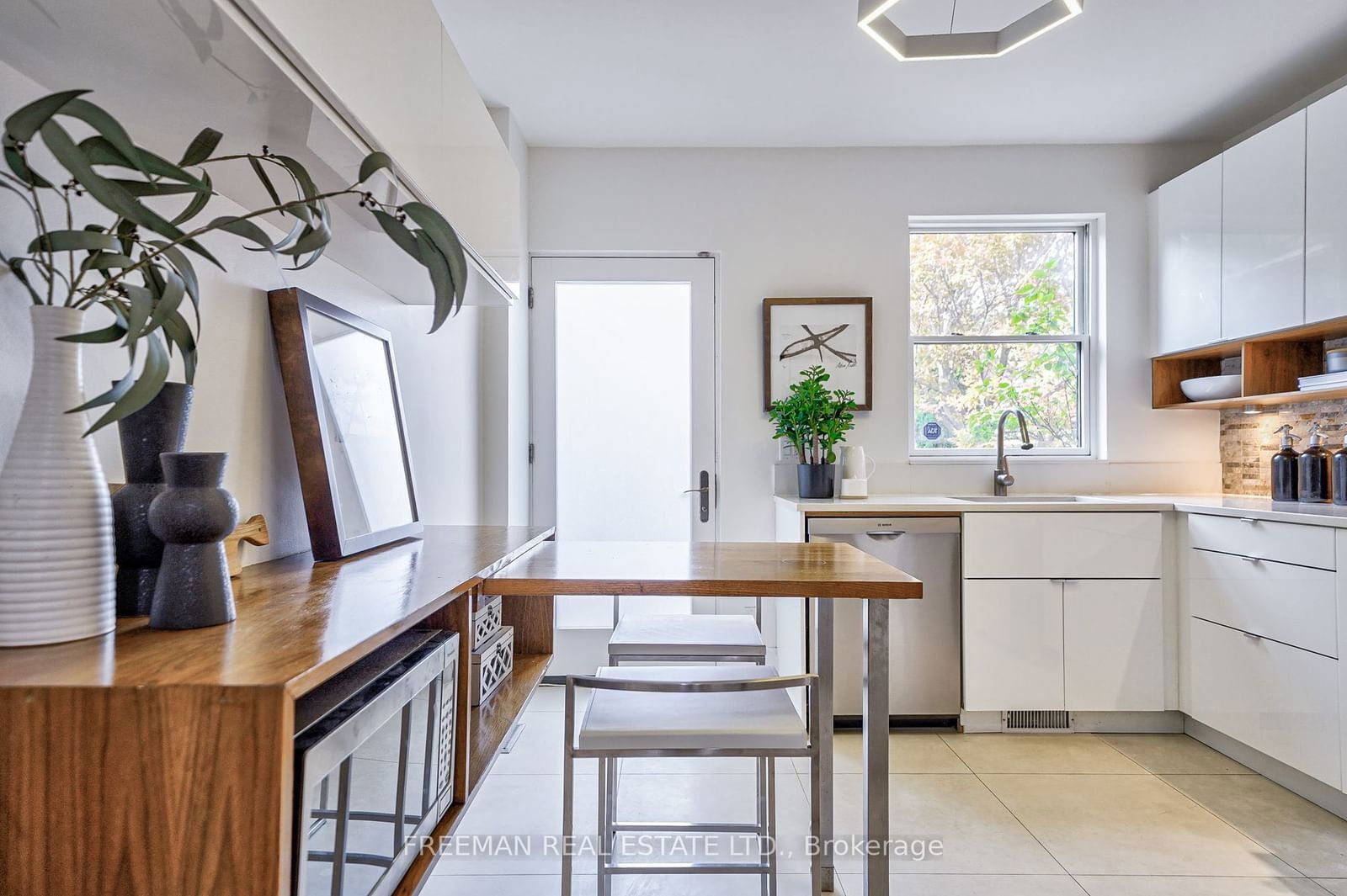 Image may contain Indoors Interior Design Plant Kitchen Art Painting Sink Sink Faucet Dining Table and Furniture