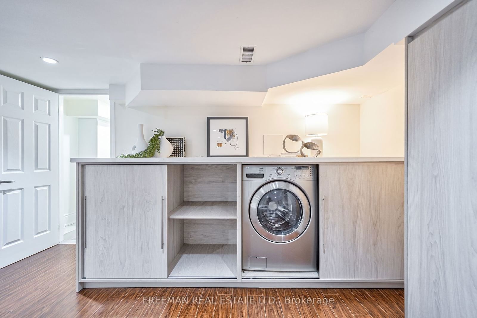 Image may contain Appliance Device Electrical Device Washer Indoors Interior Design Laundry Floor and Wood