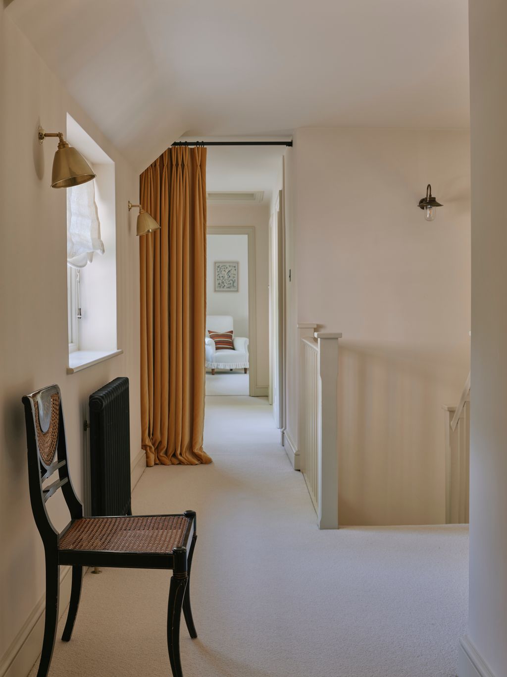 Image may contain Chair Furniture Indoors Interior Design Floor Lamp Corner and Flooring