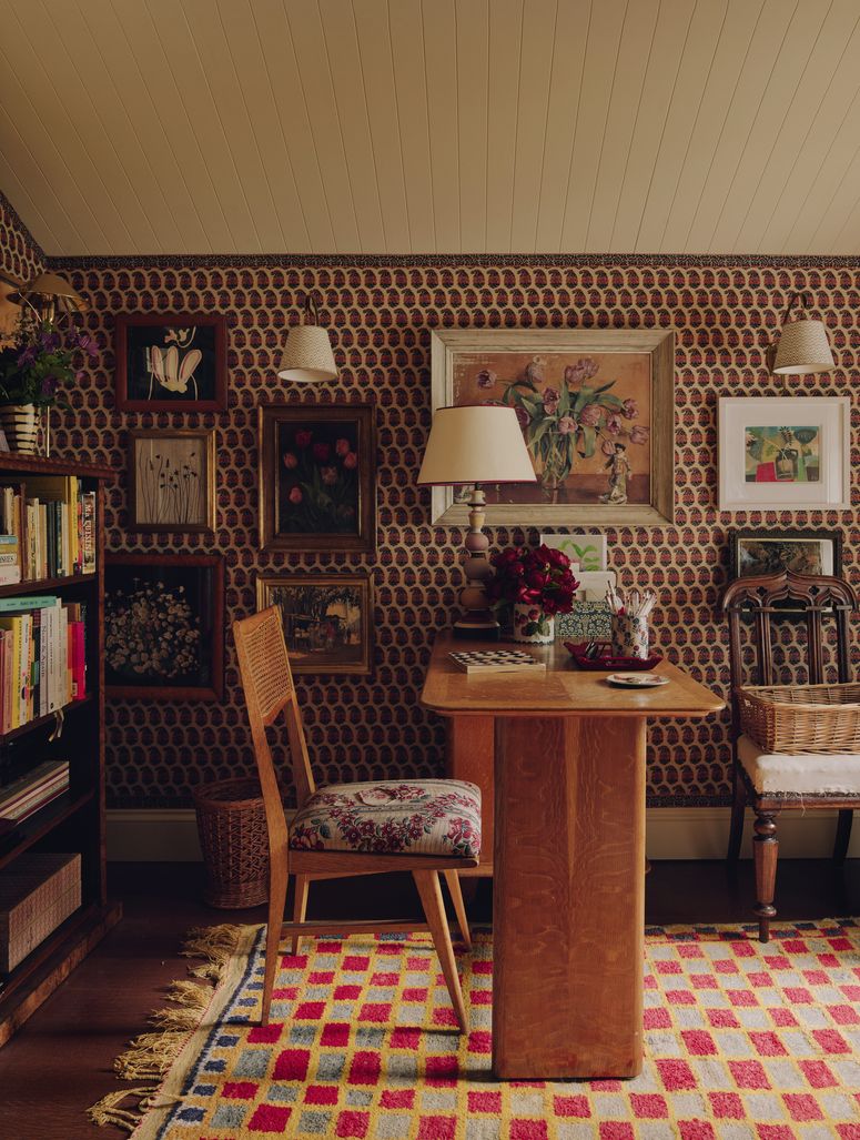 Image may contain: Indoors, Interior Design, Chair, Furniture, Lamp, Home Decor, Rug, Art, Painting, Desk, Table, and Book