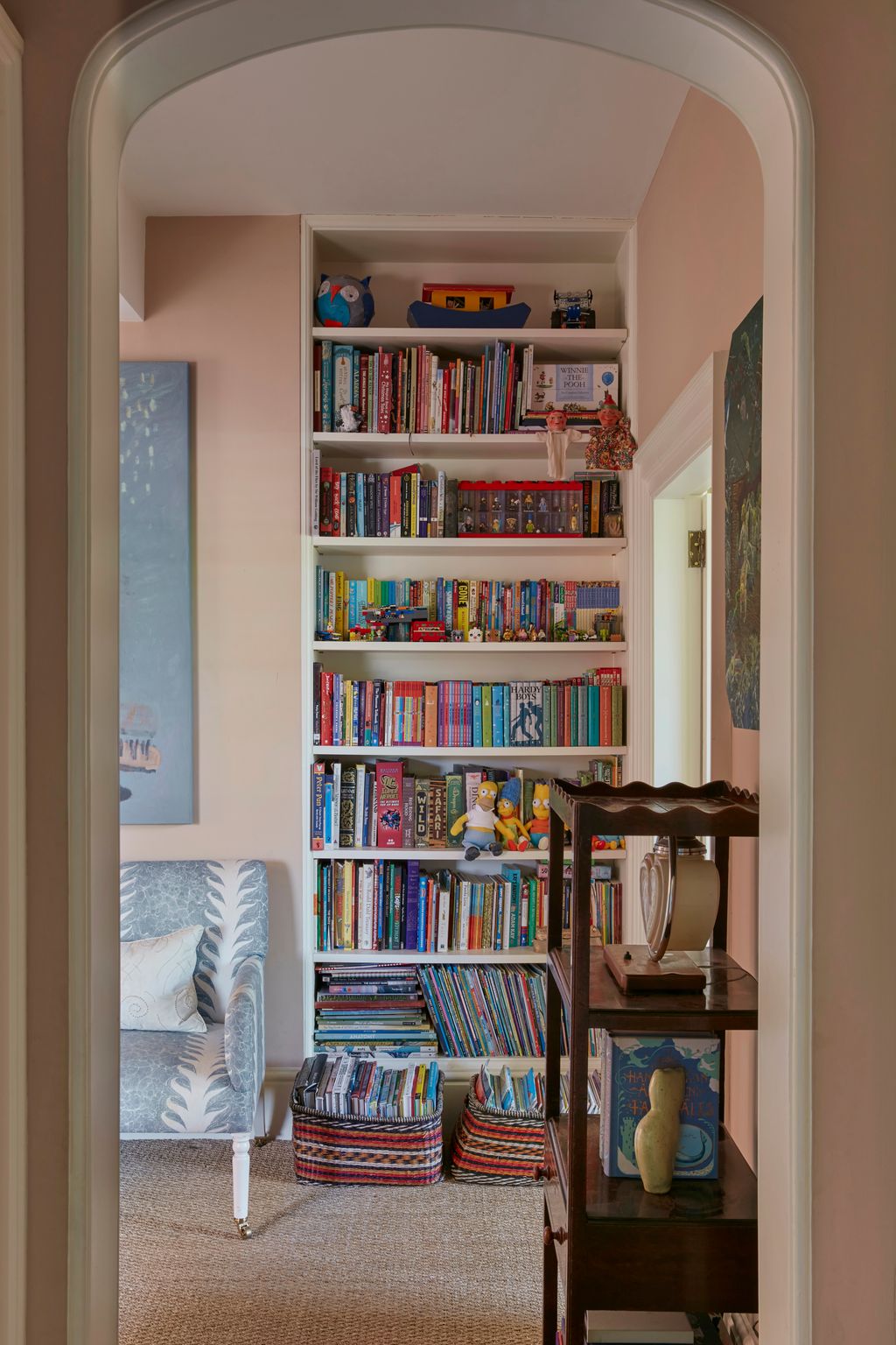 Image may contain Furniture Bookcase Accessories Bag Handbag Toy Person and Couch