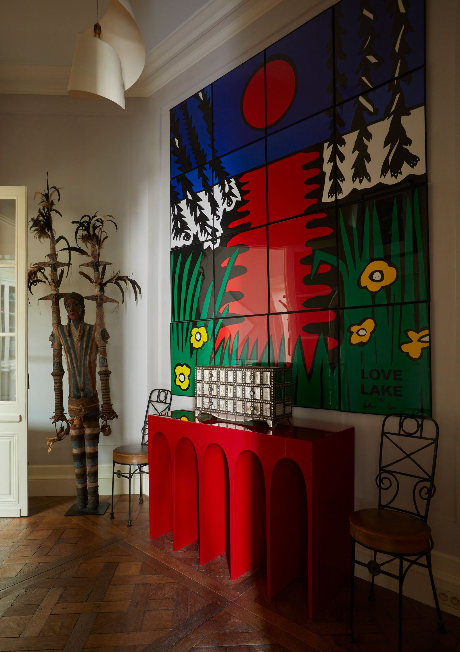 Image may contain Indoors Interior Design Chair Furniture Lamp Adult Person Table Plant Floor and Wood