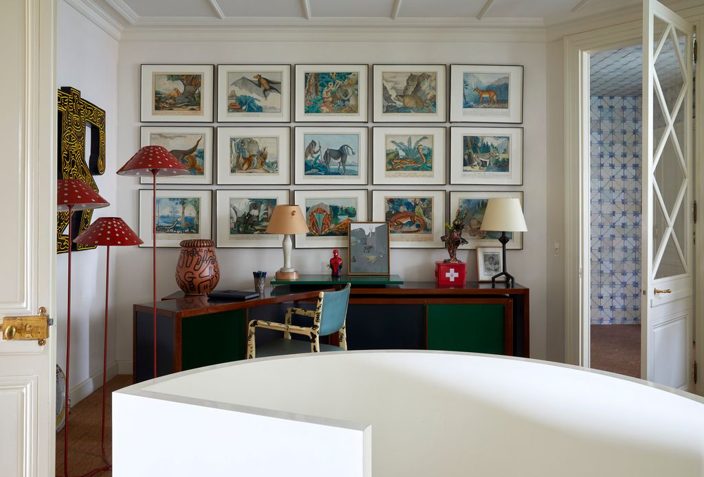 Image may contain Lamp Table Lamp Indoors Interior Design Corner Chair Furniture Person Art Painting and Desk