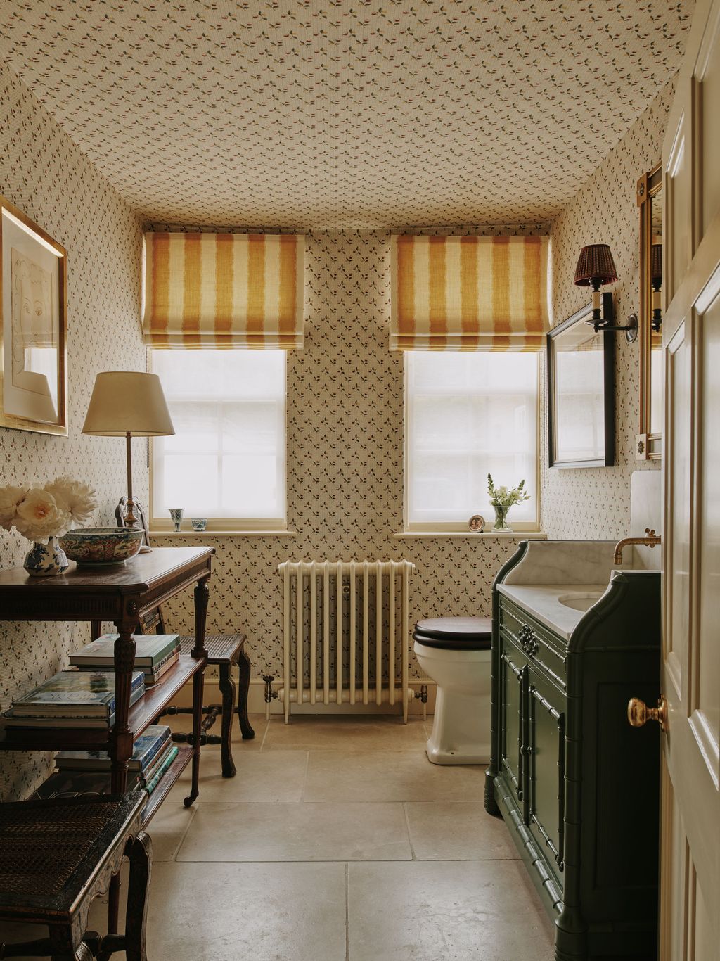 Image may contain Lamp Indoors Interior Design Sink Art Painting Sink Faucet Bathroom Room Toilet and Plant