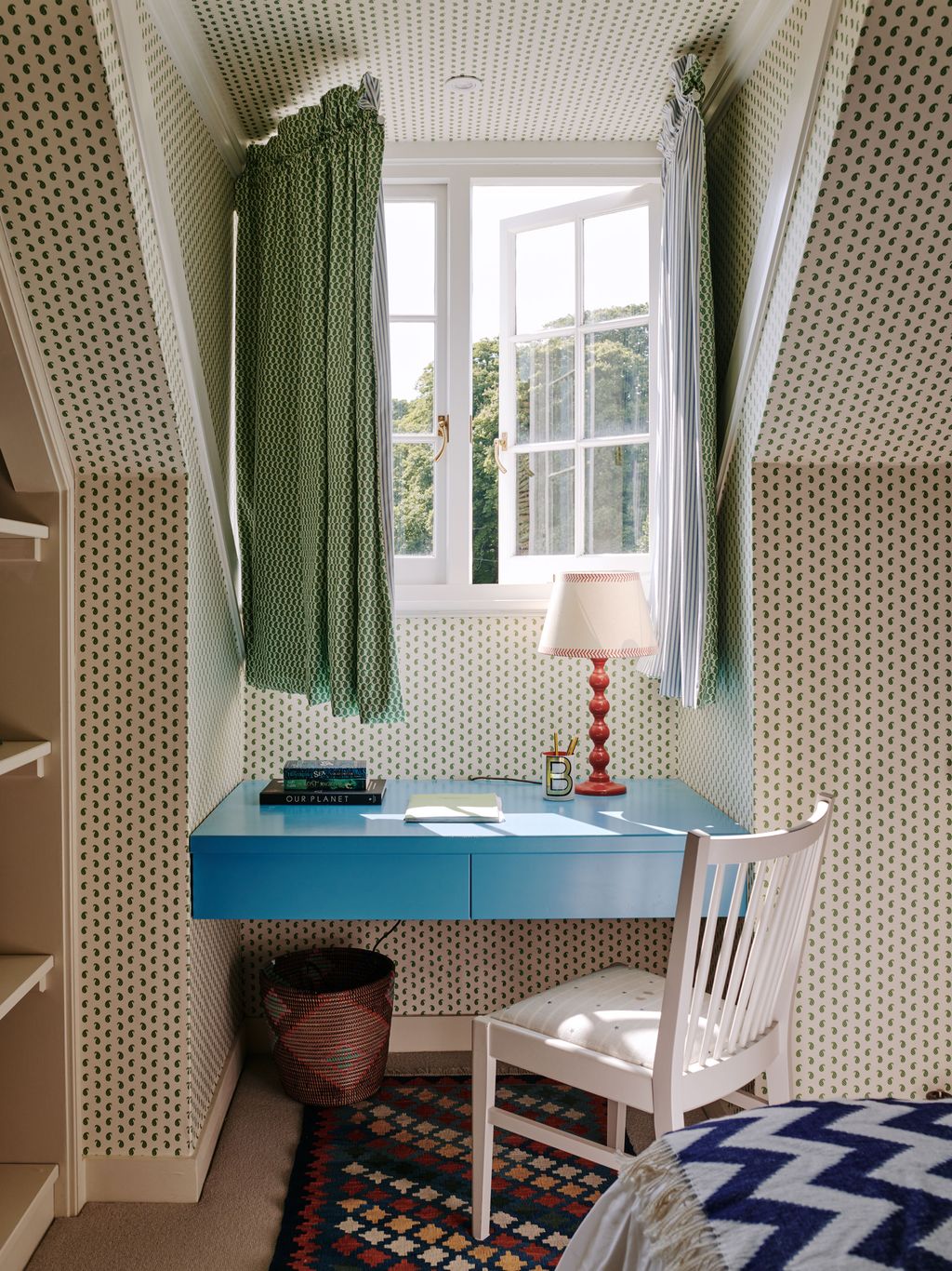 Image may contain Lamp Chair Furniture Window Indoors Interior Design Bay Window Desk Table Home Decor and Rug