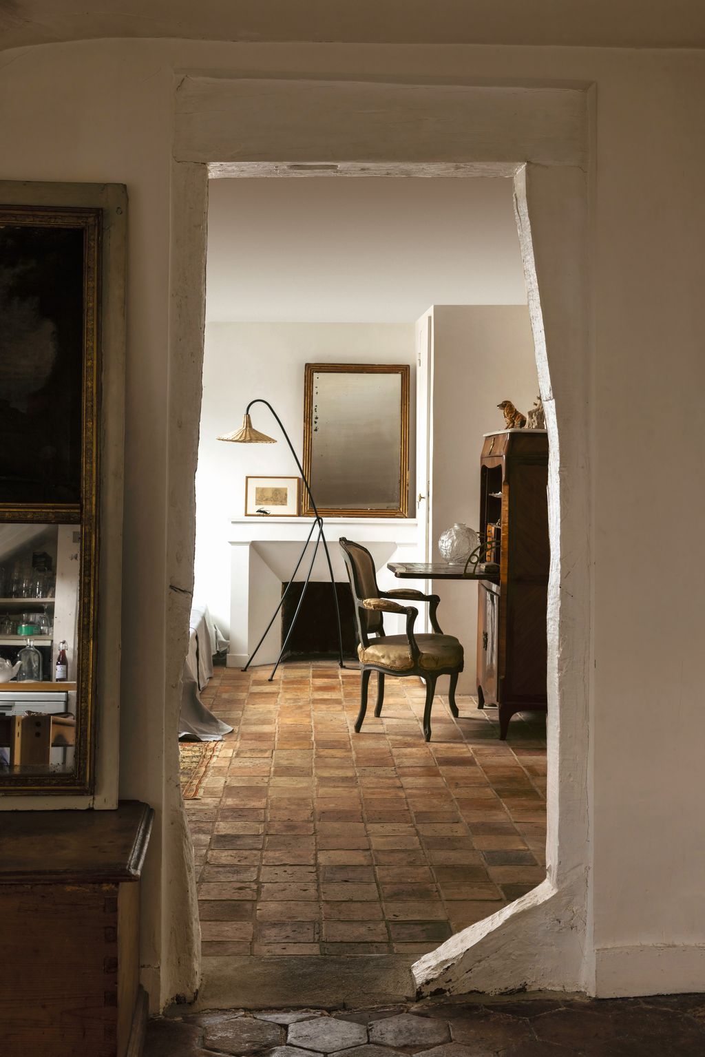 Image may contain Floor Flooring Indoors Interior Design Chair Furniture Art Painting Desk Table Lamp and Adult