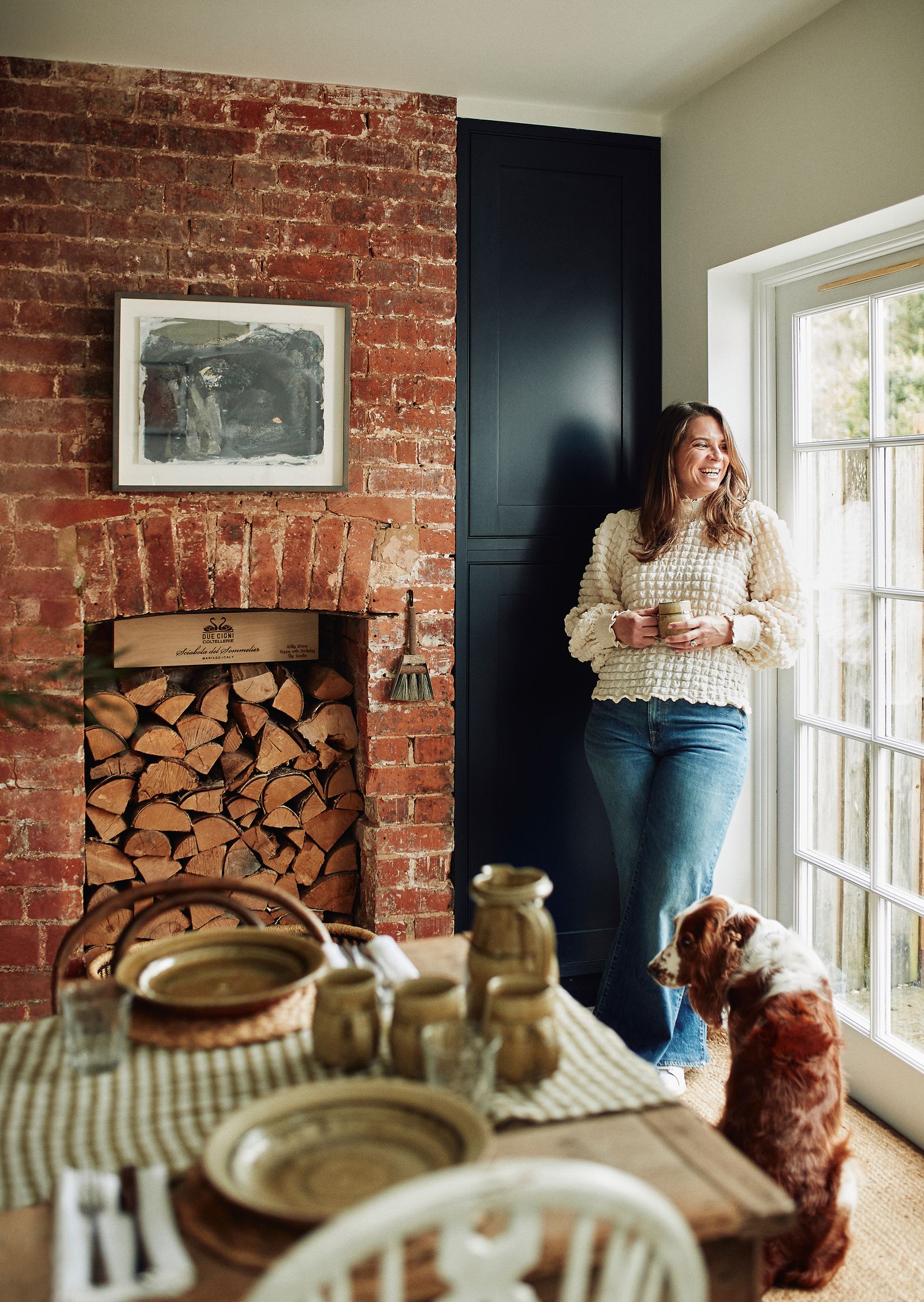 Image may contain Clothing Pants Art Painting Adult Person Cup Architecture Building Dining Room and Dining Table