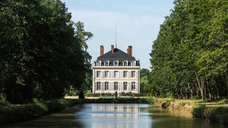 Image may contain Nature Outdoors Scenery Architecture Building Housing Water Pond House and Manor
