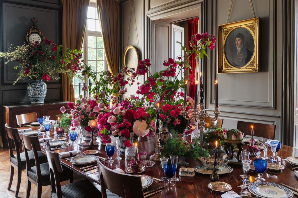 Image may contain Architecture Building Dining Room Dining Table Furniture Indoors Room Table and Flower