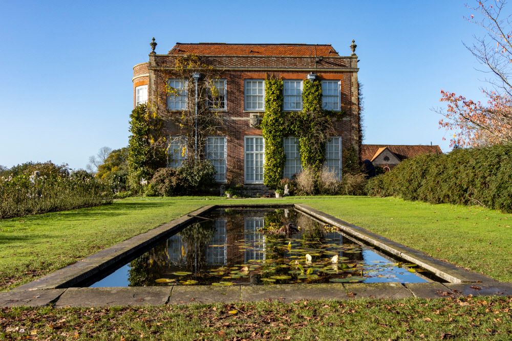 Image may contain Architecture Building Housing House Manor Villa Water Nature Outdoors Pond Grass and Plant