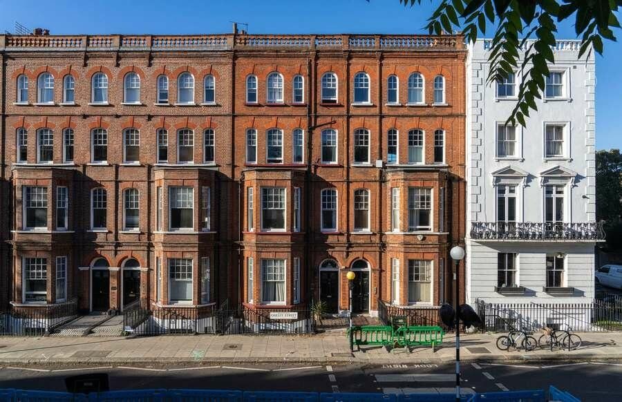 Image may contain Architecture Building Housing City House Car Transportation Vehicle Urban Row House and Bicycle