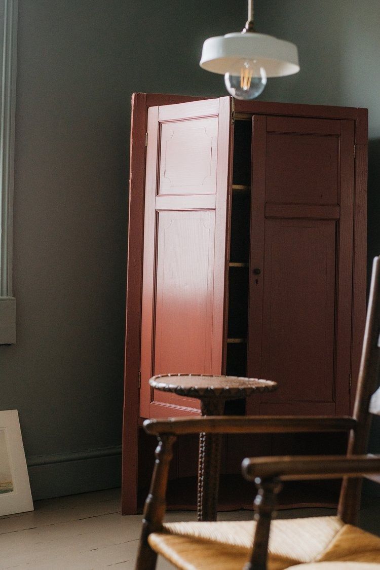 Image may contain Lamp Closet Cupboard Furniture Indoors Interior Design Chair Wood and Door