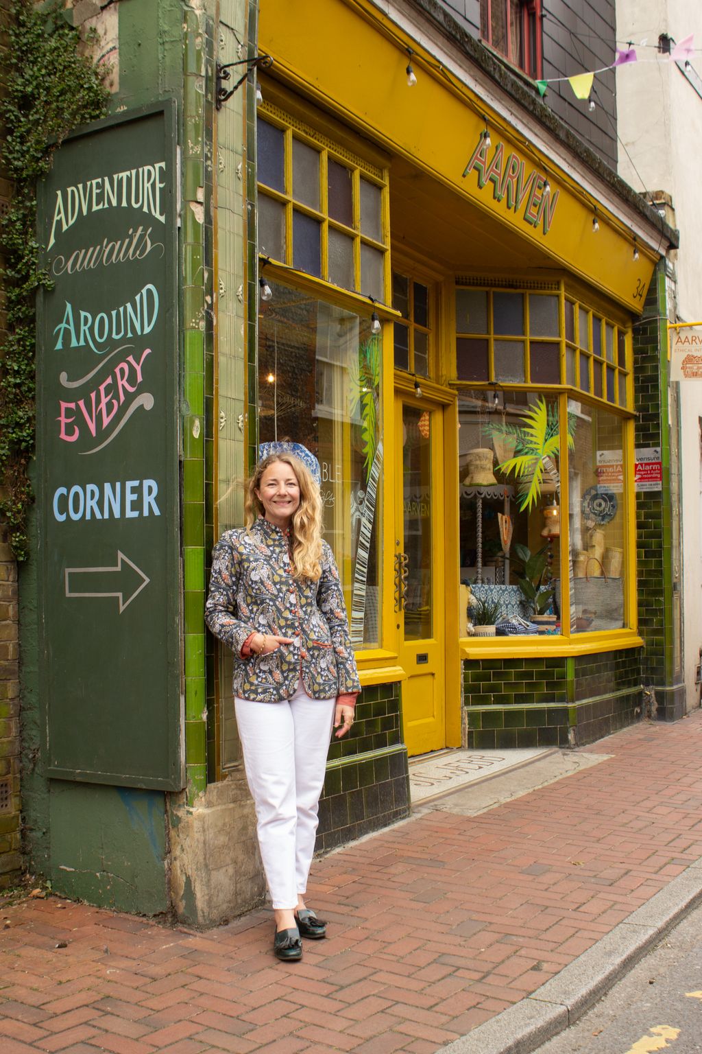 Image may contain Clothing Pants Adult Person Footwear Shoe Path Standing Walking Plant Shop Accessories and Bag