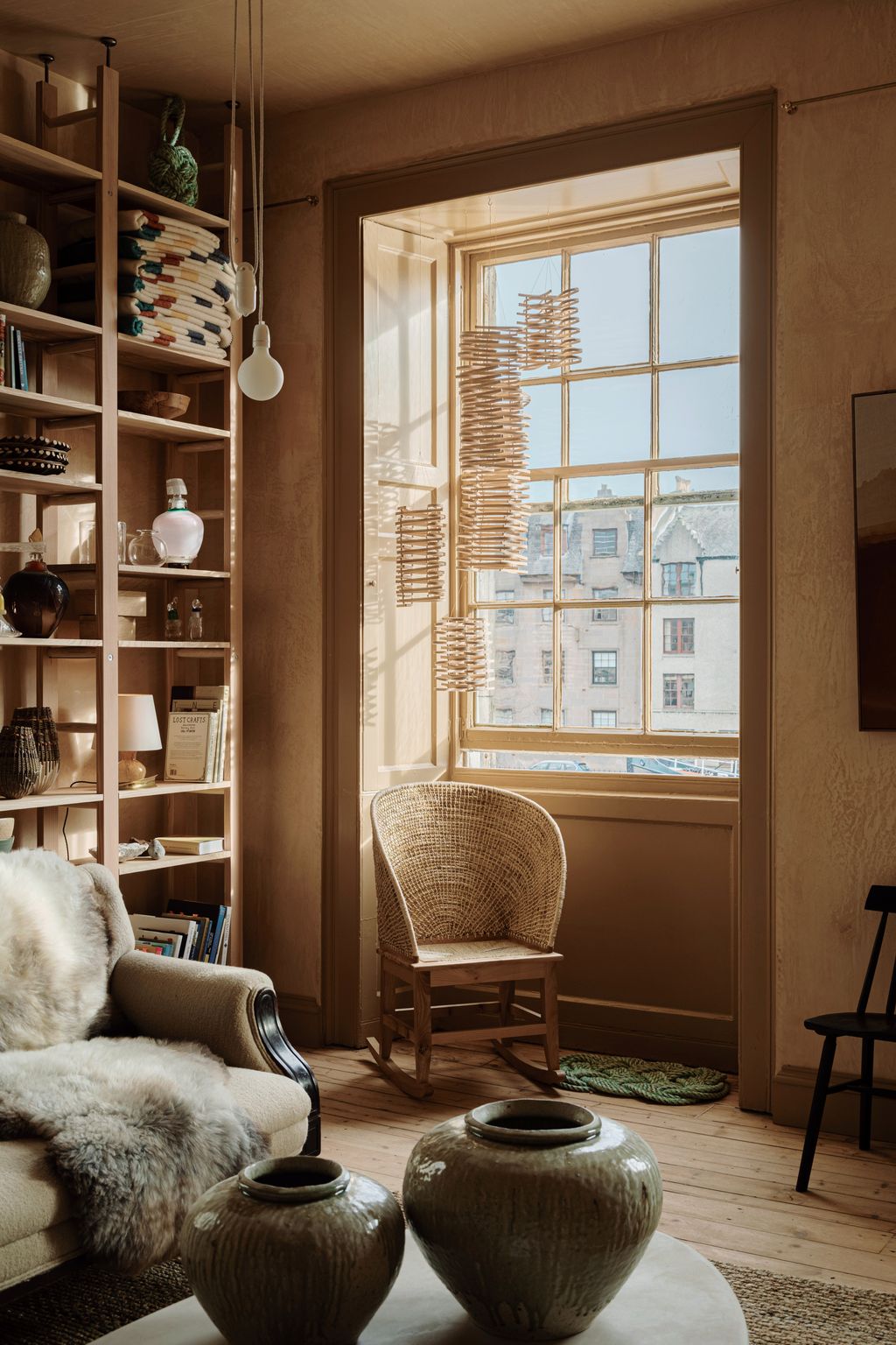 Image may contain Chair Furniture Indoors Interior Design Window Couch Lamp Home Decor Windowsill Rug and Book