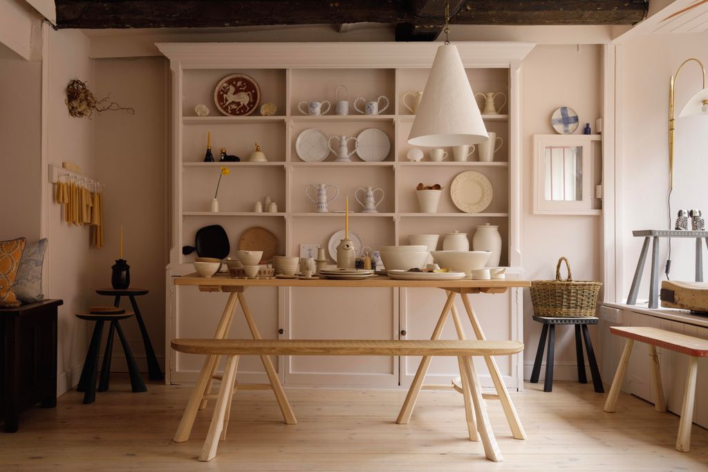 Image may contain Indoors Interior Design Wood Desk Furniture Table Cup Plate Lamp Home Decor and Architecture