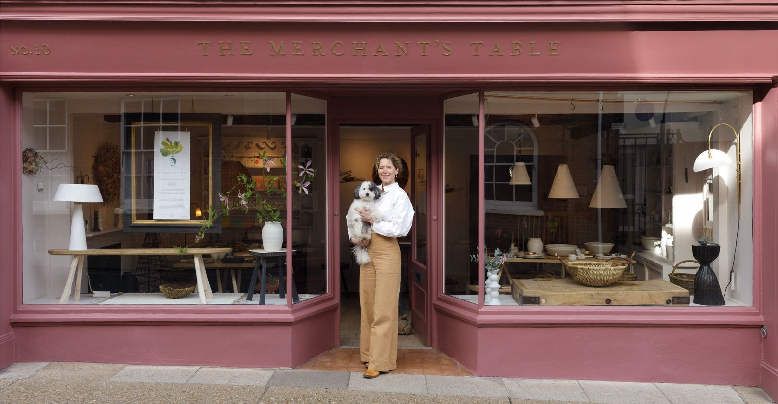 Image may contain Person Shop Lamp Plant Desk Furniture Table Boutique Animal Canine Dog Mammal and Pet