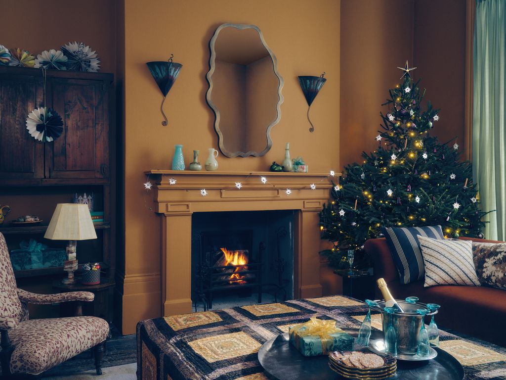 Image may contain Chair Furniture Couch Lamp Fireplace Indoors Christmas Christmas Decorations and Festival